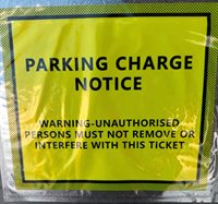 Yellow Parking Charge Notice in a transparent wallet