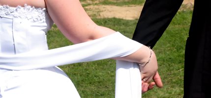 Bride and groom holding hands
