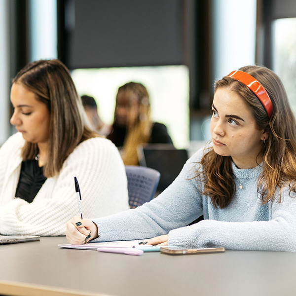 Students jotting notes during lesson