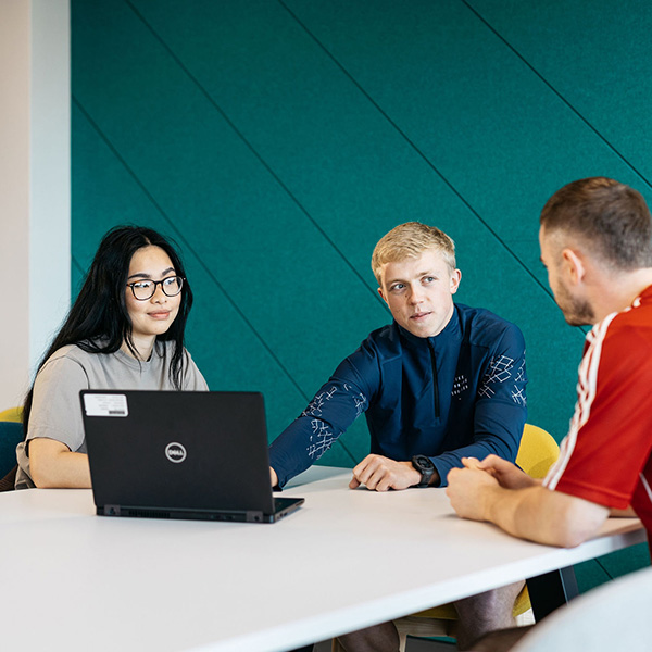 3 students using a laptop in study area