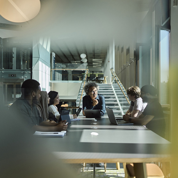 Students having group discussion with their Professor