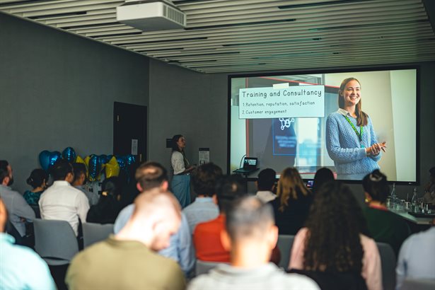Group of people listening and watching a presentation