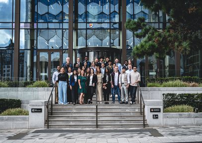 A group of people stood on steps smiling