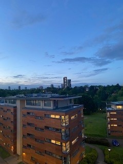 A student accommodation block pictured in the evening, as the sun is setting.