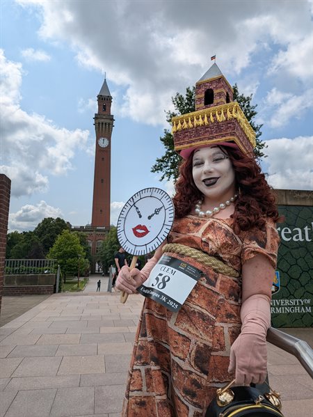 Student Clem Atkins, dressed in full drag as Bold Joe, poses with the Old Joe clocktower.