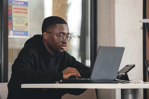 Student on laptop in library