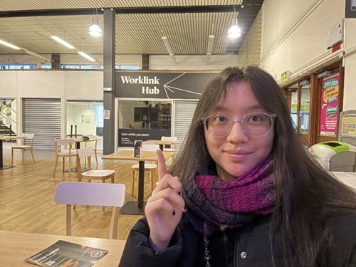 Student Content Shaper Hannah points to the Worklink Hub on campus